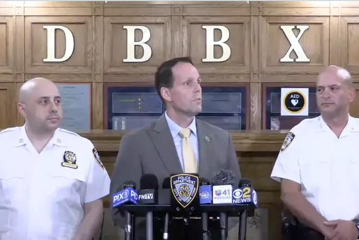Officers brief the media after an 11-year-old girl was shot in the Bronx on Monday.